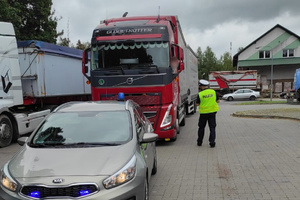 Policjant ruchu drogowego kontroluje kierowcę ciężarówki
